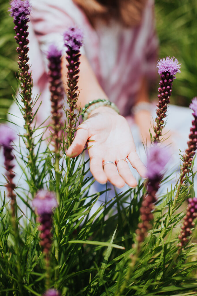 Marys-hand-reaching-out-through-flowers